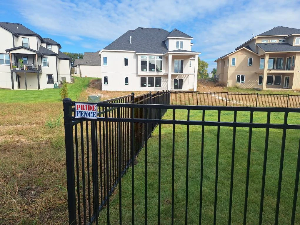 Pride Fence KC team installing a custom fence in Kansas City — licensed and insured fence contractor